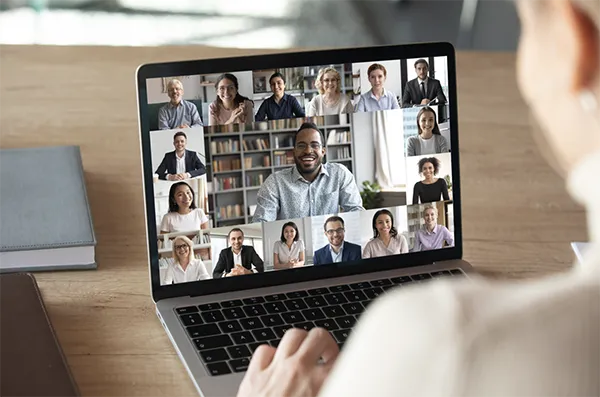 Benefits of Hybrid Working | Person attending an online meeting on laptop.