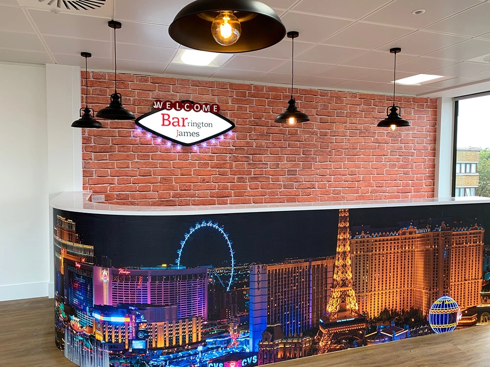 Office refurb | A new office bar, with Las Vegas design and hanging lights, a brick wall is behind