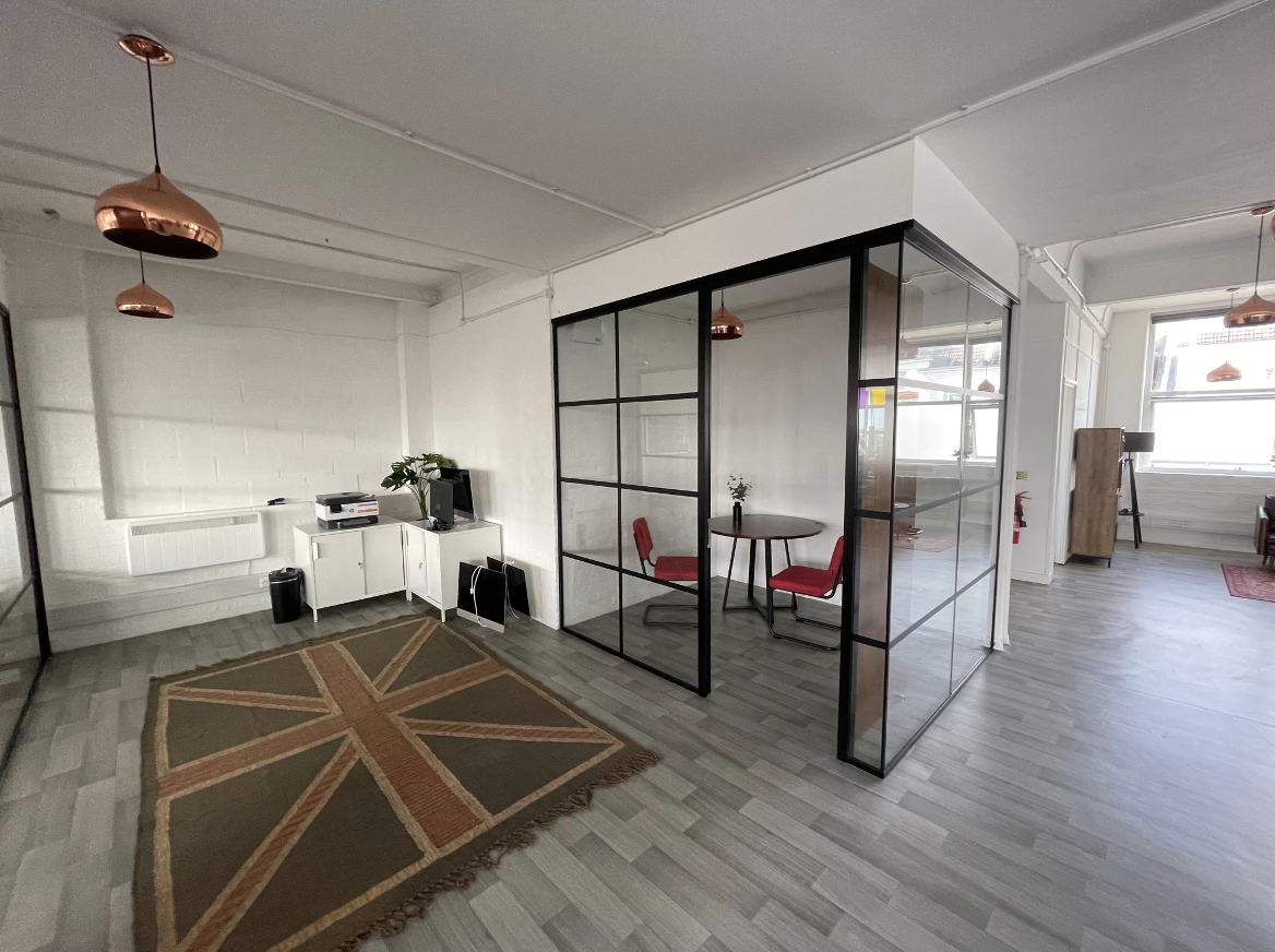 Framed glass partition | industrial partitions in office space with union jack rug