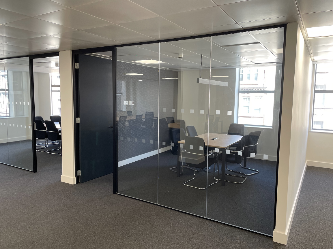 Framed glass partition | Modern glass partitions in office space, meeting room with a door