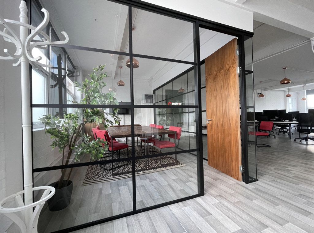 Framed glass partition | industrial partitions in office space with a coat hanger
