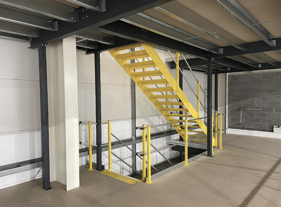 Warehouse mezzanine | Mezzanine floor with yellow safety access stairs