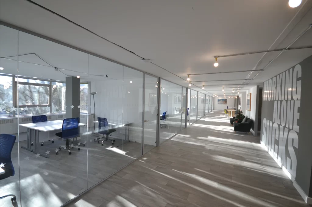 Glass wall partitions in an office space.