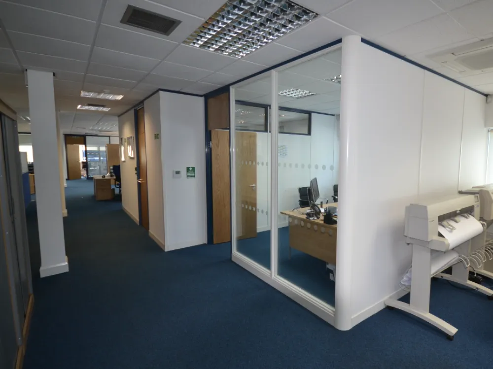 office partition wall | Glass partition in an office space, creating a meeting room. Printer off to the right.