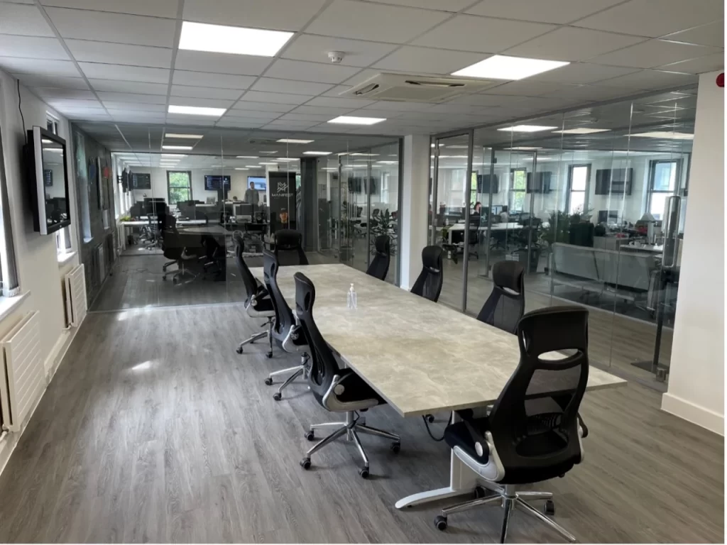 Modern boardroom with glass partitions.