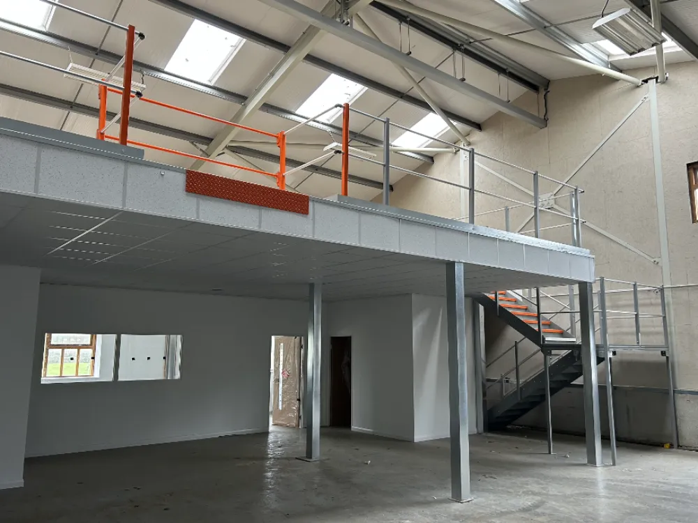 Warehouse mezzanine floors | Mezzanine floor in a warehouse space. Complete with an orange pallet gate.