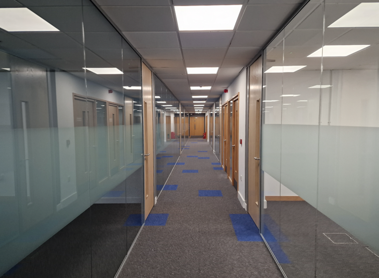 Glass partition walls for offices | Modern glass partitions in a hallway.