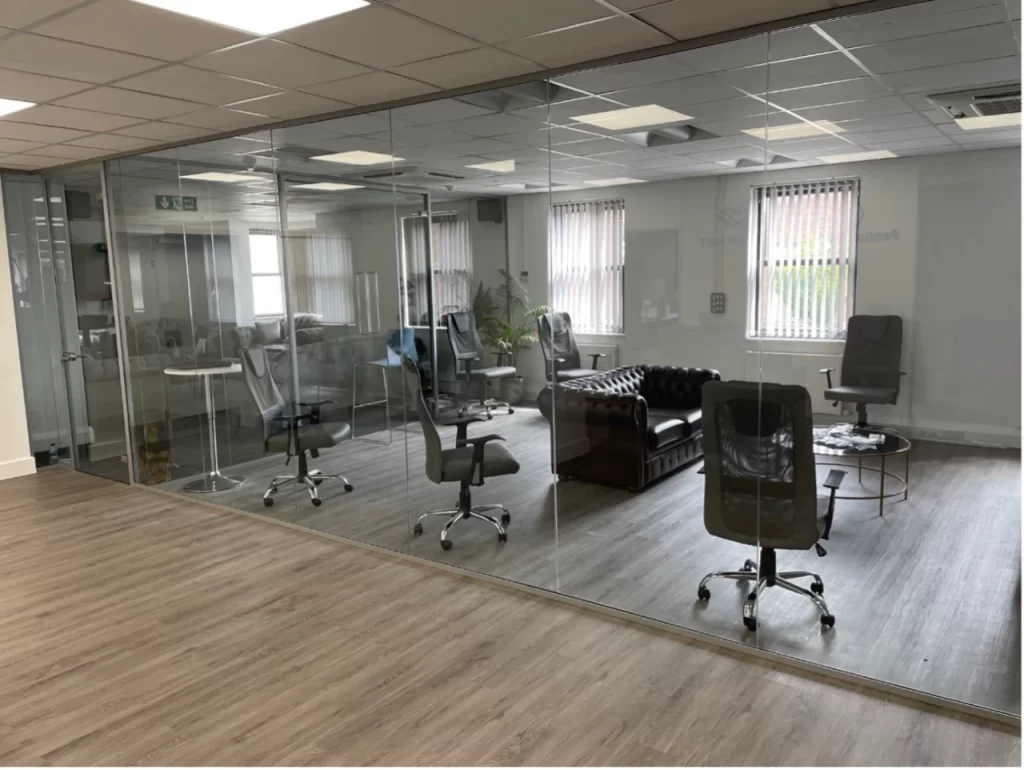 Glass wall partitions in modern boardroom.