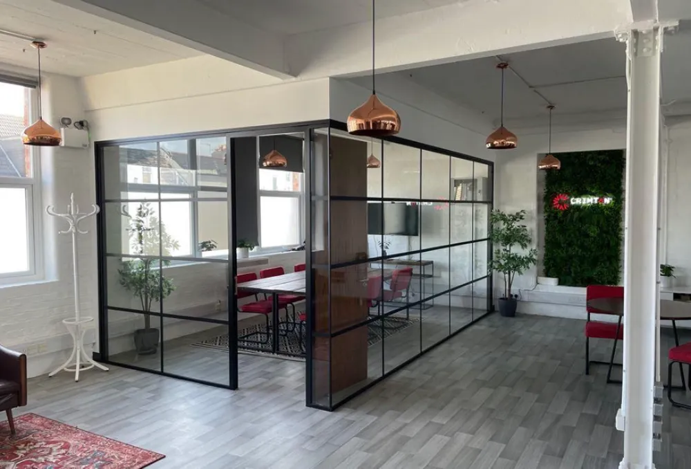 office partitioning systems | Framed glass partitions in an office space.