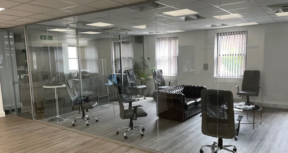 Frameless glass partition wall | Modern office space with glass partitions.
