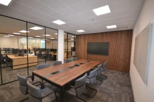 Office Refurbishment Companies | Boardroom with wooden panelling and glass walls.